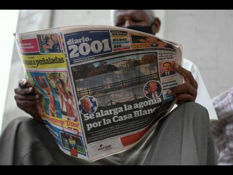 A man reads the ‘Diario, 2001’ newspaper that carries the Spanish headline: “Agony is prolonged for the White House” at a newspaper stand in Caracas, Venezuela, the day after US elections. Across the world, many were scratching their heads on Frida