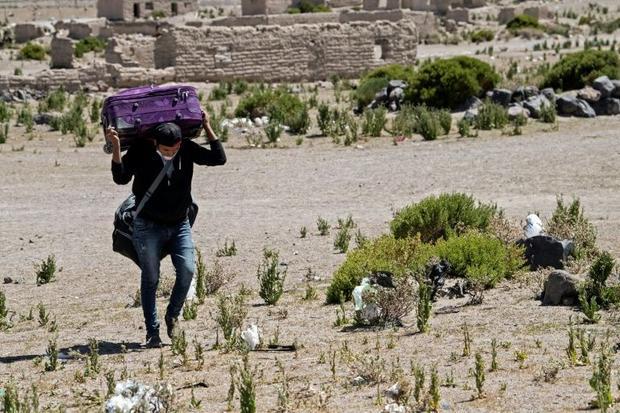 Exhausted migrants advance slowly mainly on foot completing portions of the journey by bus or taxi...